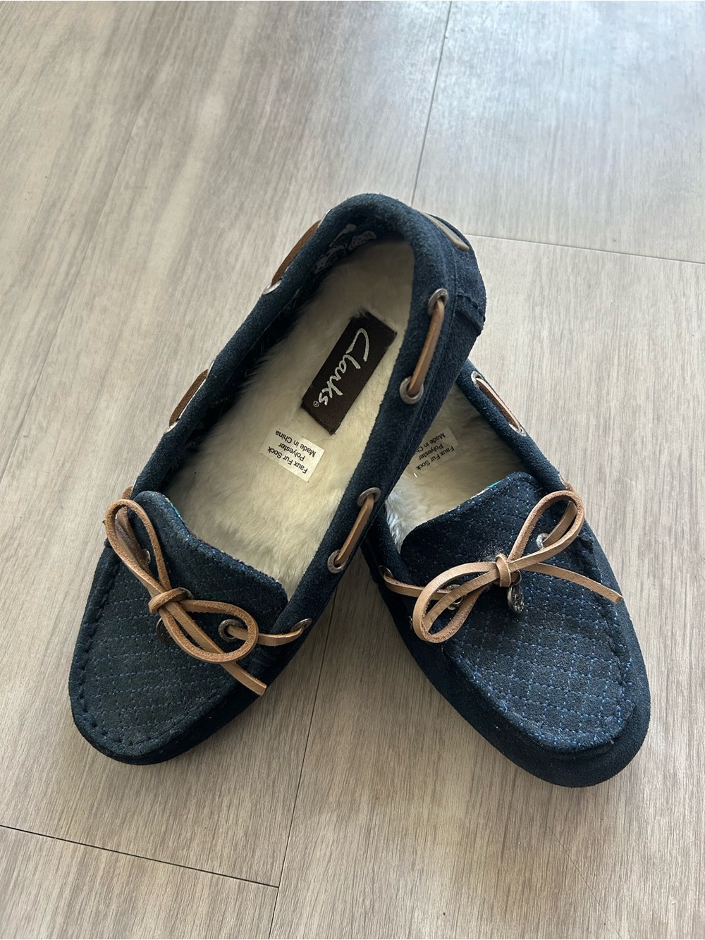 Clarks women’s Navy Moccasin Slippers with Shearling Lining
